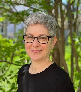 Erica Bornstein, a white woman with short hair and glasses